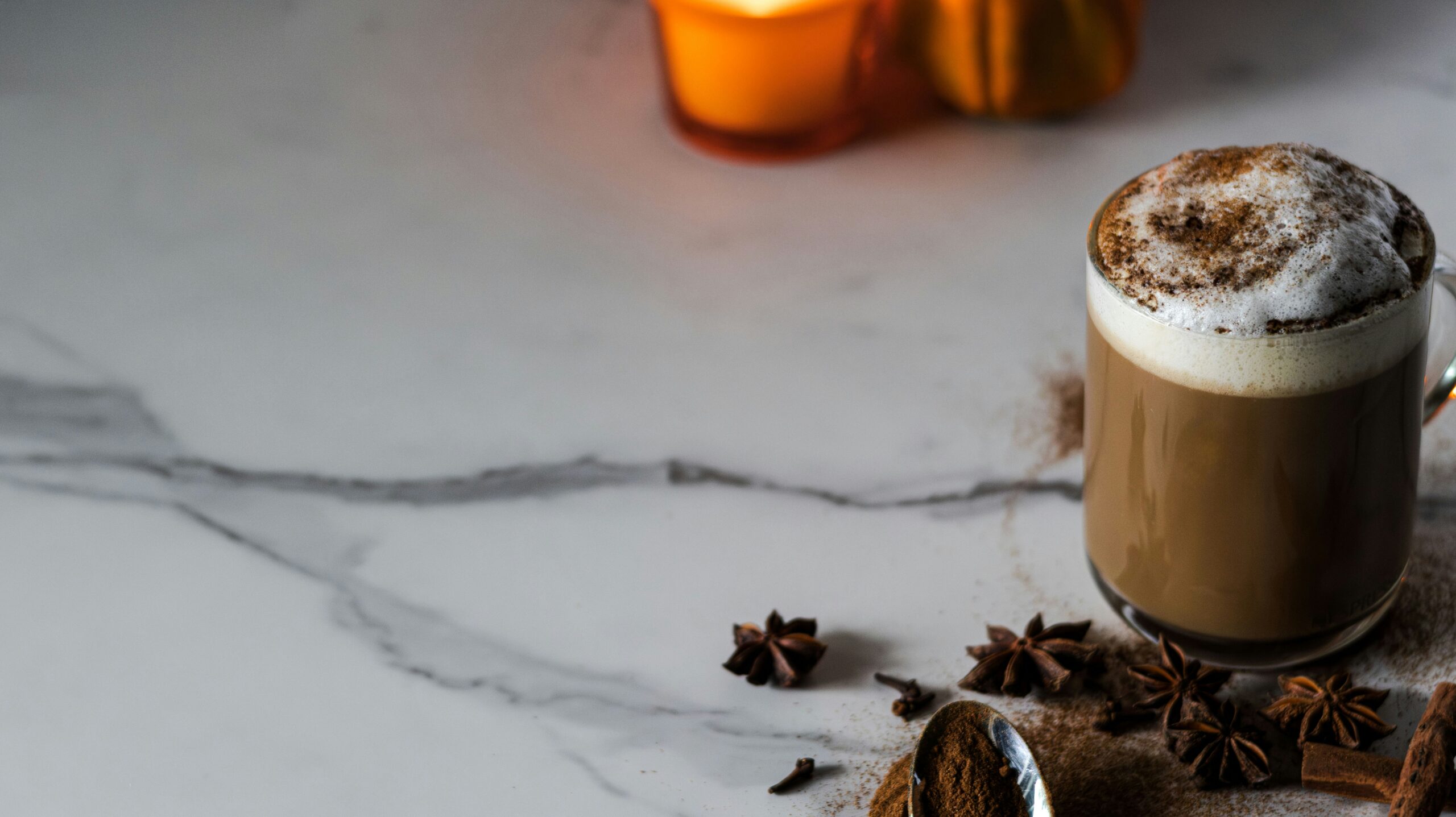 Pumpkins and warm baking spices used to make homemade pumpkin spice syrup for lattes